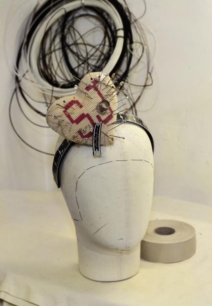 Stephen Jones Millinery Spring Summer 2018 Hats A heart pin cushion in needlepoint and printed cotton with pins and tape measure 06 Pinning